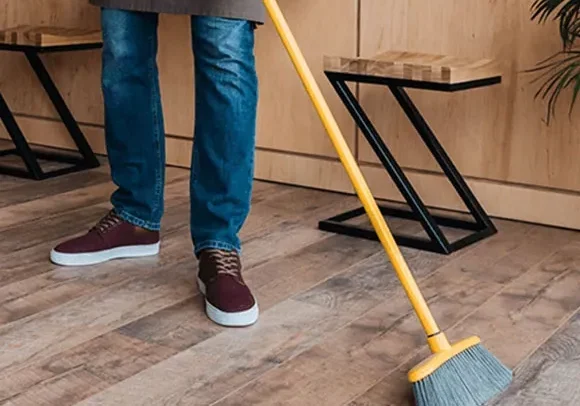 Person cleaning hardwood floors