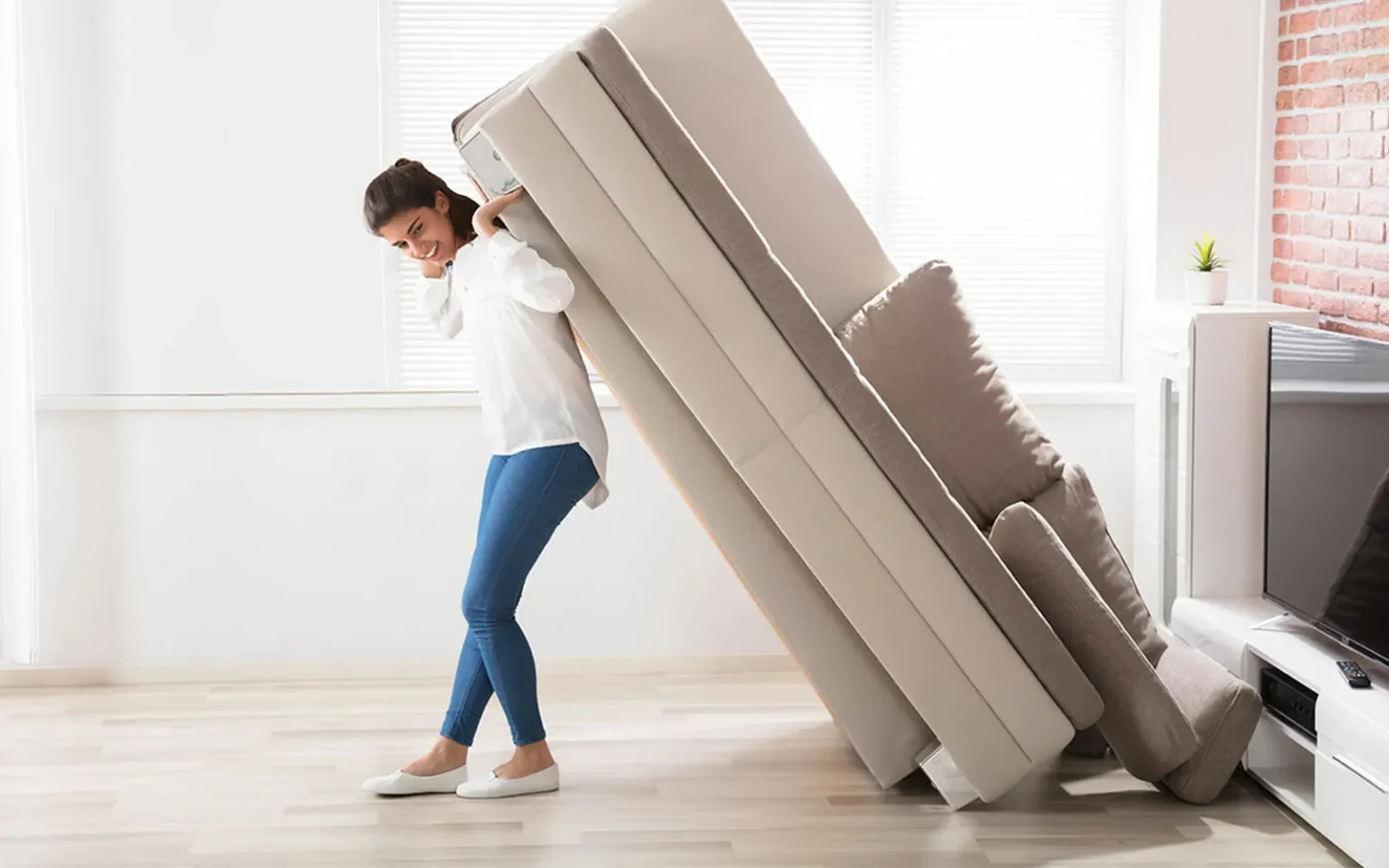 Woman lifting a heavy couch